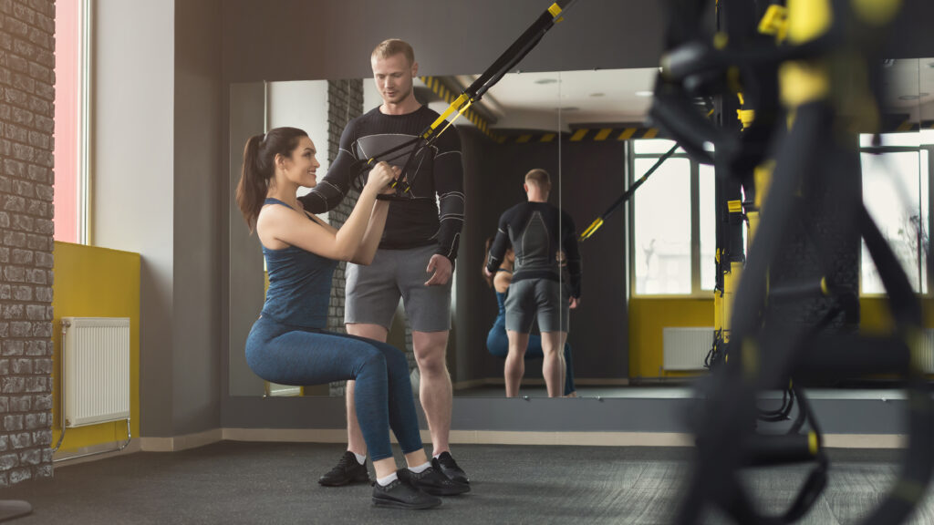 Woman training with personal trainer